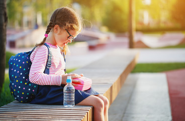 schoolgirl child eating lunch apples   at school