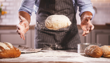 hands of baker's male knead dough