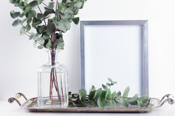 White room interior decor with eucaliptus and poster mock up