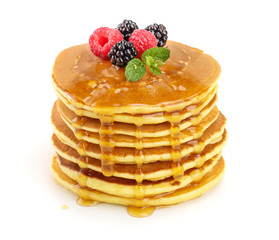 Pancakes stack with different berries and honey isolated on white background