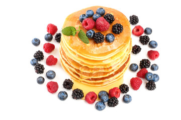 Pancakes stack with different berries and honey isolated on white background