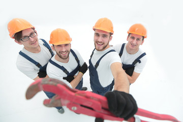 view from the top.group of builders showing a gas key.