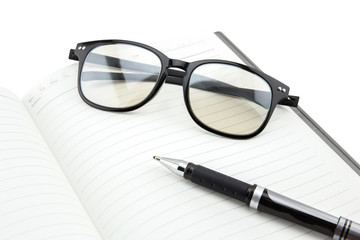 Fototapeta premium A black pen and empty open book on white background