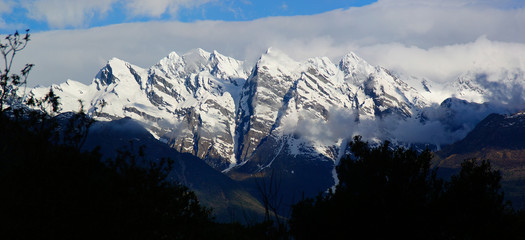 Snowy mountainous landscape of the New Zealand alps with dramatic skies, during a motorhome trip.