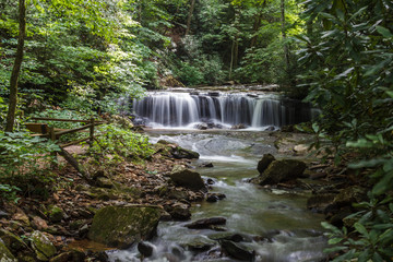 Beautiful high waterfall among the forest in summer. Waterfall and Botanical Preserve Pearson's Falls, Saluda, NC, USA