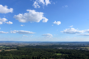 Obraz premium Amazing Landscape view on the beautiful forests, alpine mountains and idyllic fields of South Germany with a blue sky before sunset with clouds