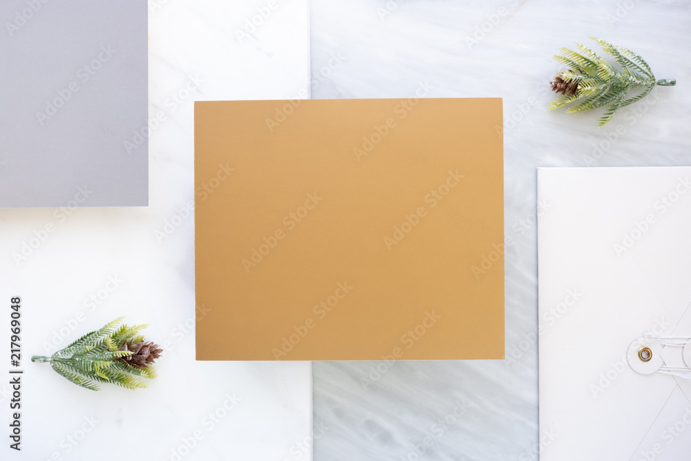 Poster Top view of blank gold card overlap on envelop and grey card with pine leaf on two layer step of marble table top.Mock up template for display of design .luxury business items.