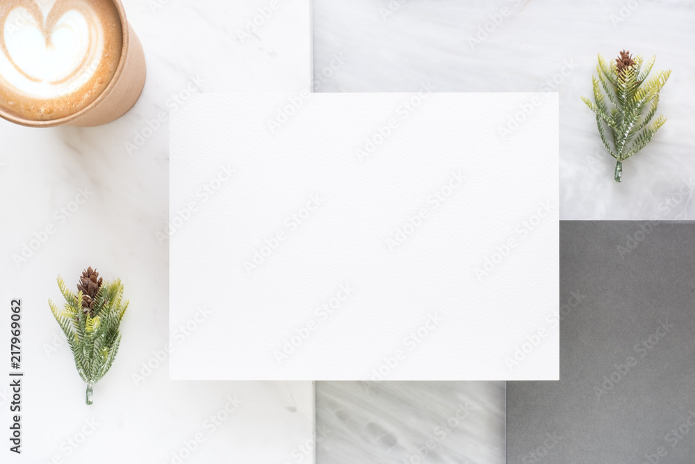 Aufkleber Top view of blank white card overlap on grey card with hot coffee cup and pine leaf on two layer step of marble table top.Mock up template for display of design .luxury business items.