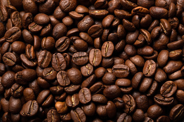 Close-up roasted coffee beans background. Top view