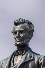 Edinburgh, Scotland, UK - June 13, 2012: Just the head and chest of Abraham Lincoln bronze statue on Old Calton Cemetery isolated against blue sky.