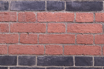 brick wall painted black and orange background. texture, architecture.