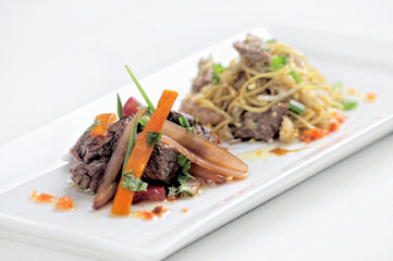 Peruvian dish called Lomo Saltado made of tomato, beef meat and onions mixed with French fries.