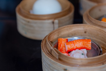 Closeup dim sum steamed in bamboo basket. Chinese breakfast style in southern of Thailand.