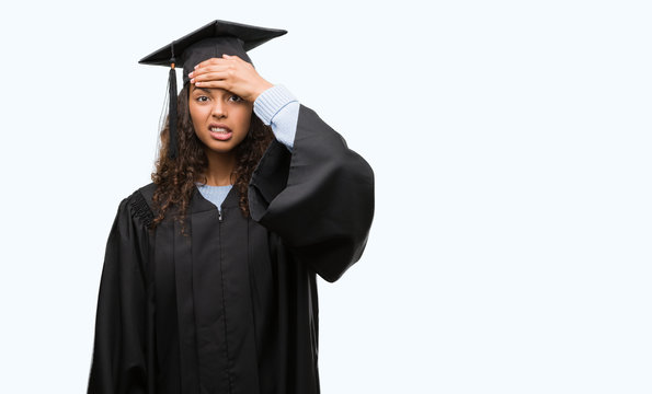 Young hispanic woman wearing graduation uniform stressed with hand on head, shocked with shame and surprise face, angry and frustrated. Fear and upset for mistake.