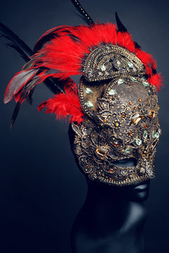 Golden mask with precious stones and feathers