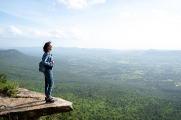 A woman backpacker standing on rock