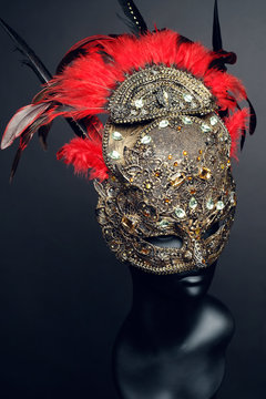 Golden mask with precious stones and feathers