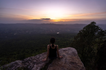 silhouette woman sitting on mountain