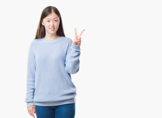 Young Chinese woman over isolated background showing and pointing up with fingers number two while smiling confident and happy.