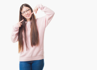 Obraz na płótnie Canvas Young Chinese woman over isolated background wearing glasses smiling confident showing and pointing with fingers teeth and mouth. Health concept.