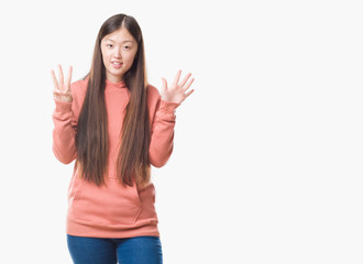 Young Chinese woman over isolated background wearing sport sweathshirt showing and pointing up with fingers number eight while smiling confident and happy.