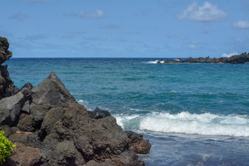 Black sand beach with lava rock on the island of Maui, Hawaii