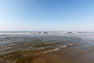 Fototapeta na wymiar Waves on the Atlantic Ocean, with clear water at dawn, Sunset Beach, North Carolina