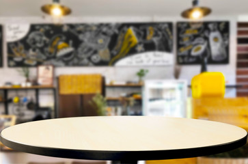 Fototapeta na wymiar Selected focus empty brown wooden table and Coffee shop or restaurant blur background with bokeh image. for your photomontage or product display