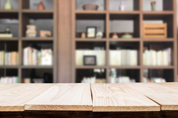 Wooden board empty table space platform in front of blurred library Of The background - can be used for display or montage your products. Mock up for display of product.