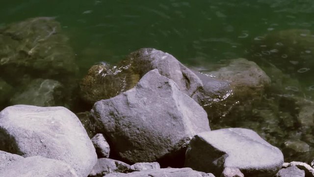 Water "breaks" on a rock in the sea.