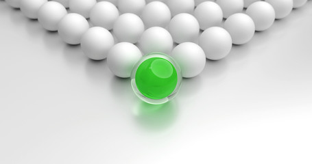 Konzept zur Führung eines Teams. Grüne Kugel, gefolgt von vielen weißen Kugeln. Symbolisch für einen Anführer.