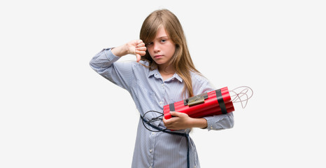 Young blonde child holding dynamite bomb with angry face, negative sign showing dislike with thumbs down, rejection concept