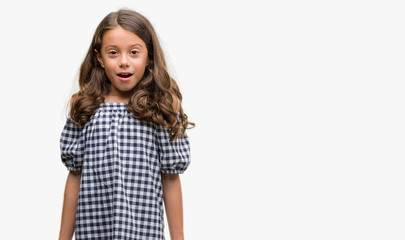 Brunette hispanic girl wearing black and white dress scared in shock with a surprise face, afraid and excited with fear expression