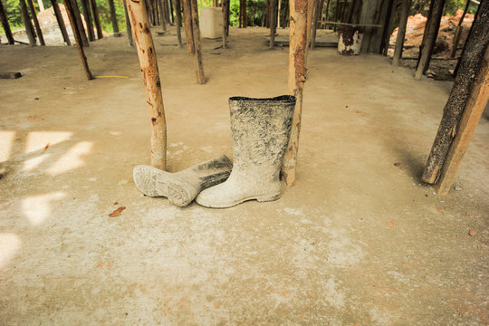 Dirty rubber boots at the construction sute