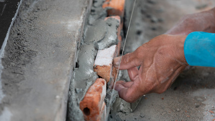 The mechanic is using brick masonry