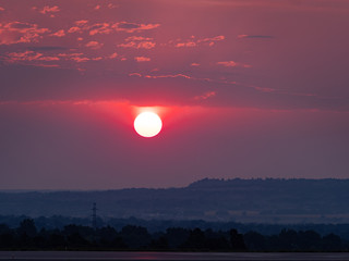 Obraz premium The Sun Rising Through Polluted Air From Forest Fires 