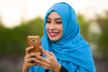 lifestyle isolated portrait of young happy and beautiful tourist woman in muslim hijab head scarf...