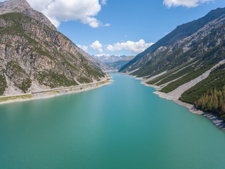 Naklejka na ściany i meble Drone aerial view of the Lake Livigno an alpine artificial lake. Italian Alps. Italy