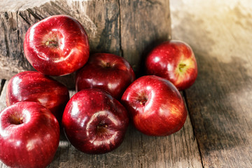Red apples on old wooden table