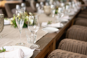 Wedding Banquet or gala dinner. The chairs and table for guests, served with cutlery and crockery. Covered with a linen tablecloth runner. party on terrace