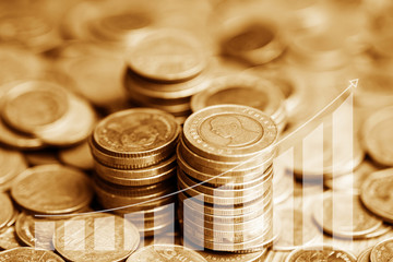 Stack of coins with growing graph for business finance concept
