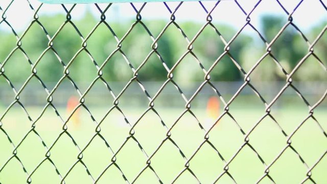 Close-up of a fence at a baseball field