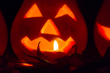 Fototapeta premium halloween candles and pumpkins in the dark