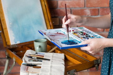 art painting hobby. creative leisure. artist mixing watercolors preparing to draw picture. talent...