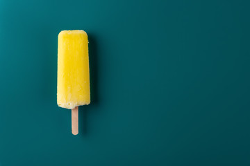 yellow popsicle on a navy blue background