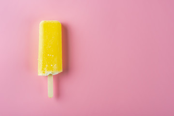 yellow popsicle on a pink background