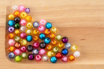 Fototapeta na wymiar Beads, colorful beads on Wooden Tray background.