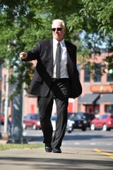 Pointing Adult Male Politician Walking On Sidewalk