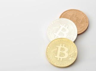 Three Bitcoins Coins on white