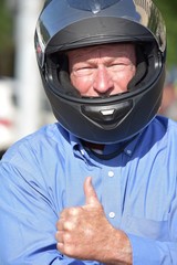 Older Man Wearing Motorcycle Helmet Thumbs Up